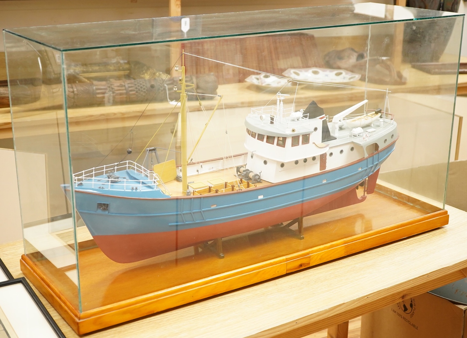 A model of a fishing trawler ship constructed from a kit by Billings Boats models, of painted wood construction, finished to a high standard with a good level of detail, presented in a glazed cabinet on a wooden base, ca